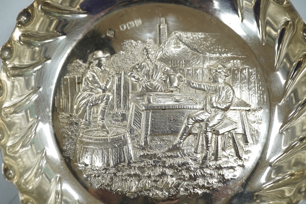 A late Victorian silver shallow dish embossed with imbibers, Mappin Brothers, London, 1897, 13.5cm, 3.8oz. Condition - good